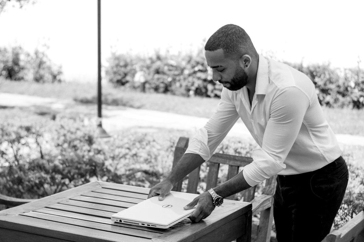 Felipe Pereira fechando o notebook ao ar livre